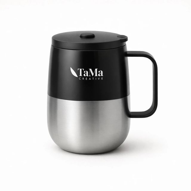 Caneca térmica com misturador, preta e prata, com alça preta e a marca TaMa em branco na parte de cima.