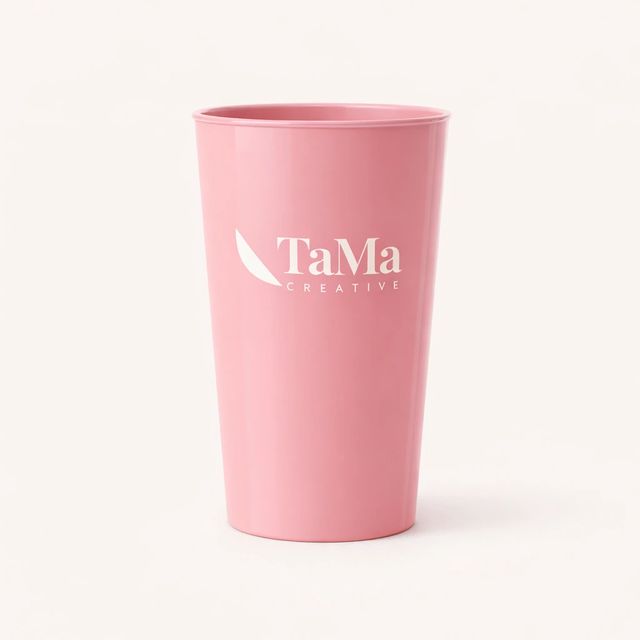 Copo long drink rosa com a marca TaMa em branco.